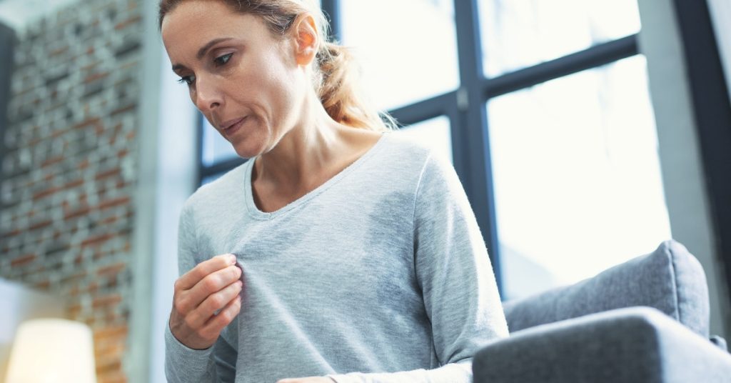 Woman Experiencing Perimenopause Hot Flash
