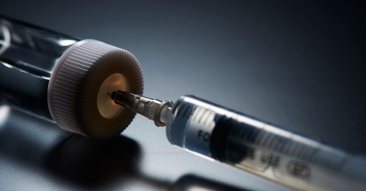 Prescription peptide vial and injection syringe representing provider-guided peptide therapy