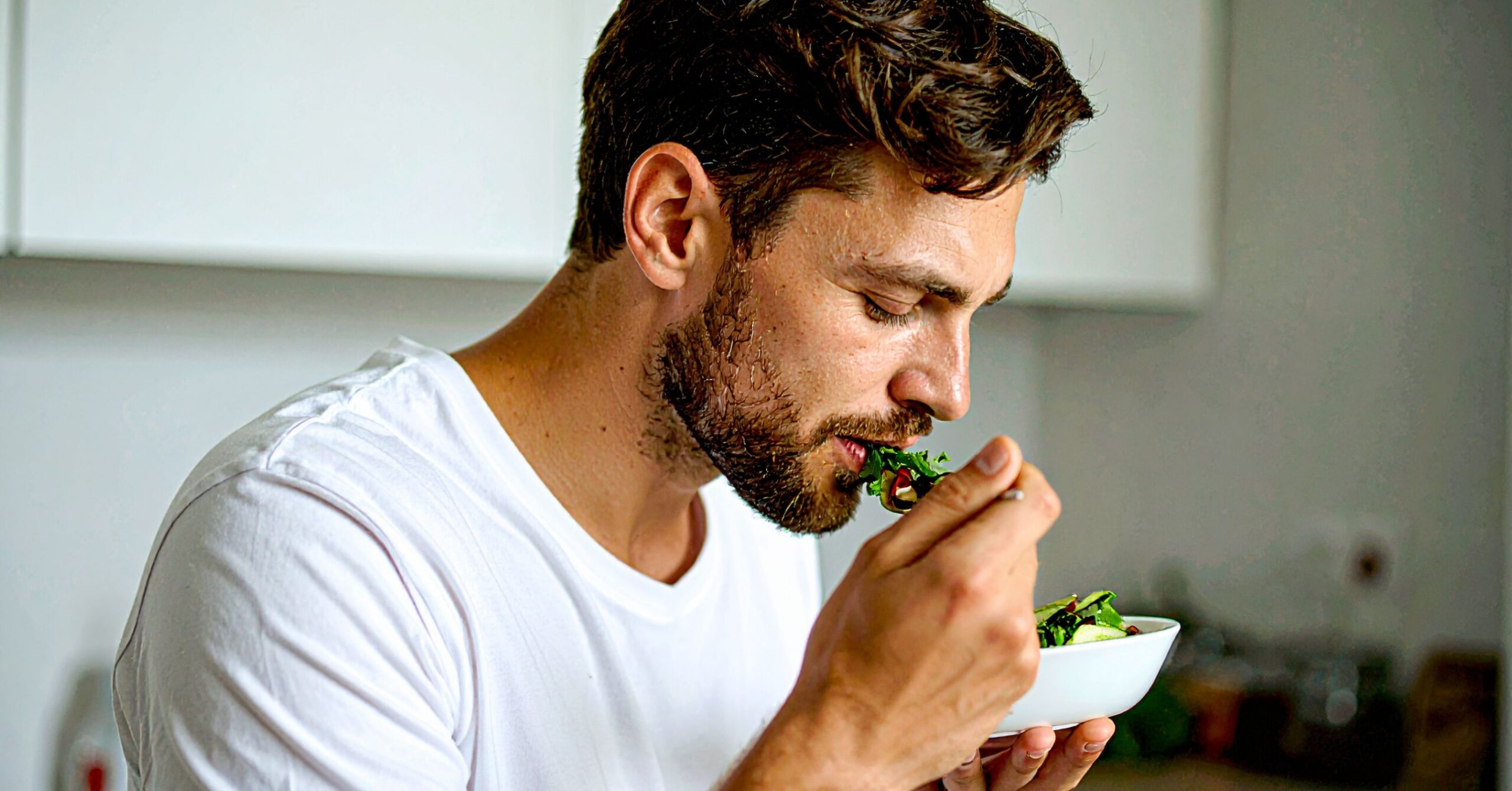 Man eating a meal while on testosterone replacement therapy (TRT), illustrating increased appetite