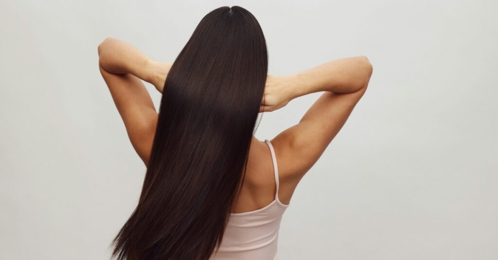 Woman with healthy, full hair showing strong hair growth and balanced hormone levels