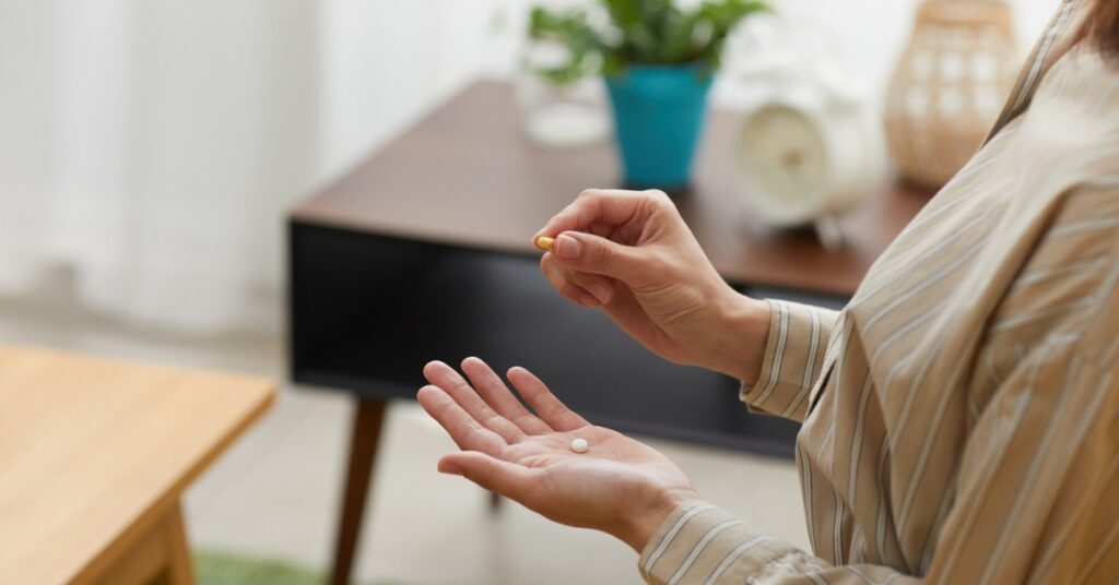 Woman taking progesterone medication for perimenopause symptoms
