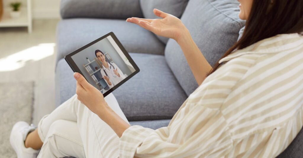 Woman speaking with a healthcare provider over a video call about hormone health and anxiety symptoms