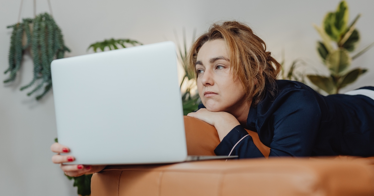 Woman sitting alone looking unhappy and emotionally overwhelmed, representing symptoms associated with hormone imbalance
