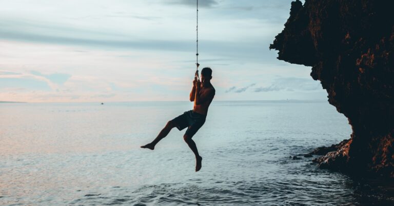 Man sitting alone on a swing representing mood changes associated with low testosterone