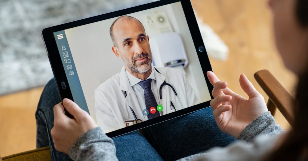 Man speaking with a healthcare provider during a virtual consultation about low testosterone symptoms and hormone health