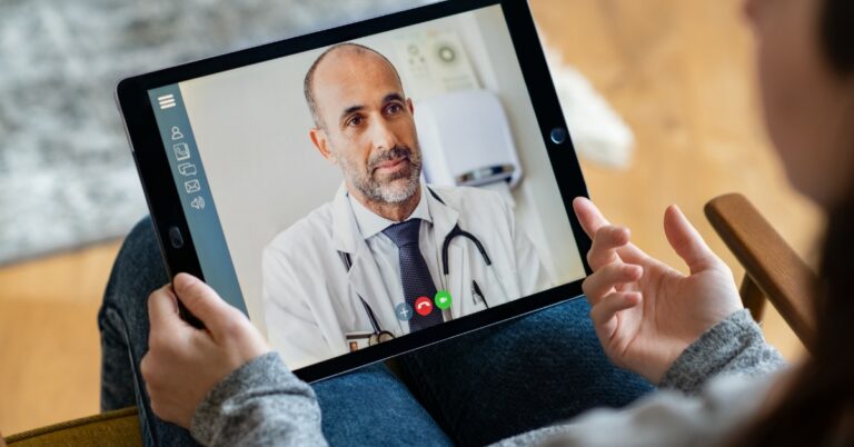 Man speaking with a healthcare provider during a virtual consultation about low testosterone symptoms and hormone health