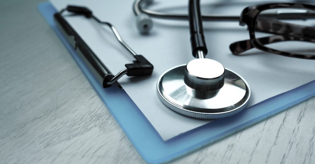 Clipboard with medical forms, stethoscope, and healthcare supplies representing personalized patient care