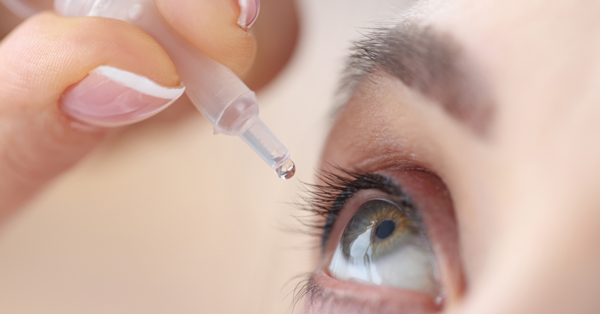 Woman using eye drops to relieve dry eyes during menopause