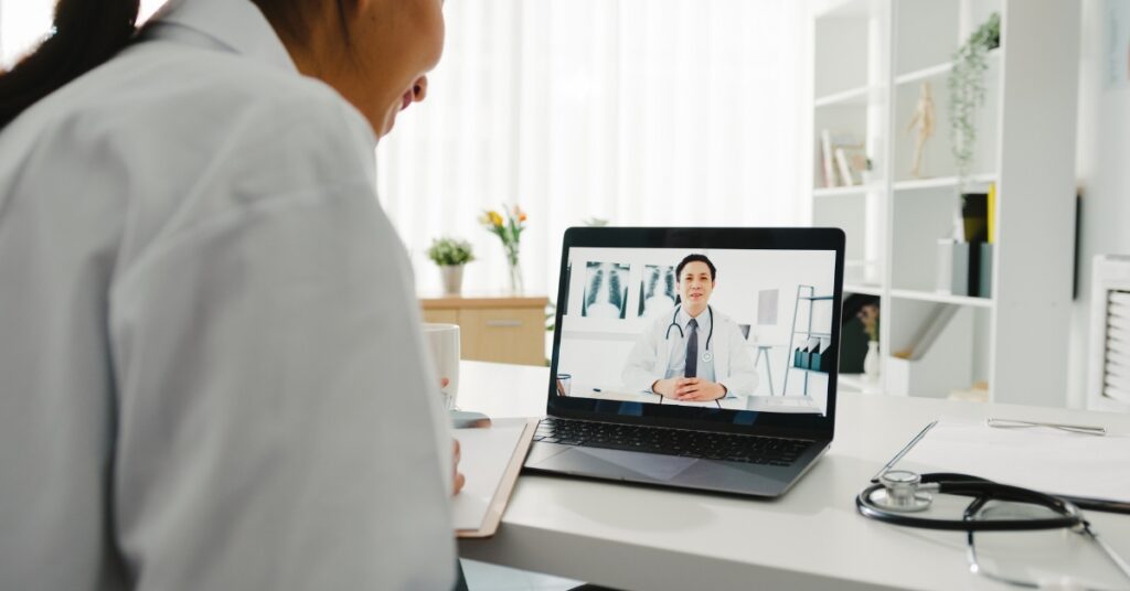 Woman speaking with a healthcare provider during an online menopause consultation
