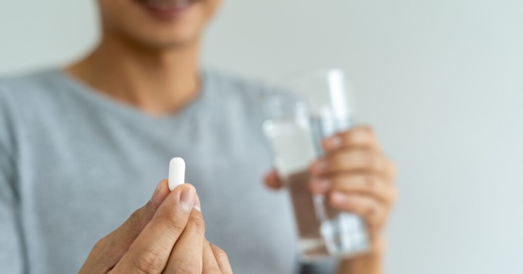 Man taking prescribed medication as part of a provider-guided testosterone treatment plan