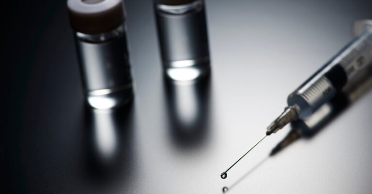 Gray peptide vials and a syringe representing gray market peptides and peptide therapy.