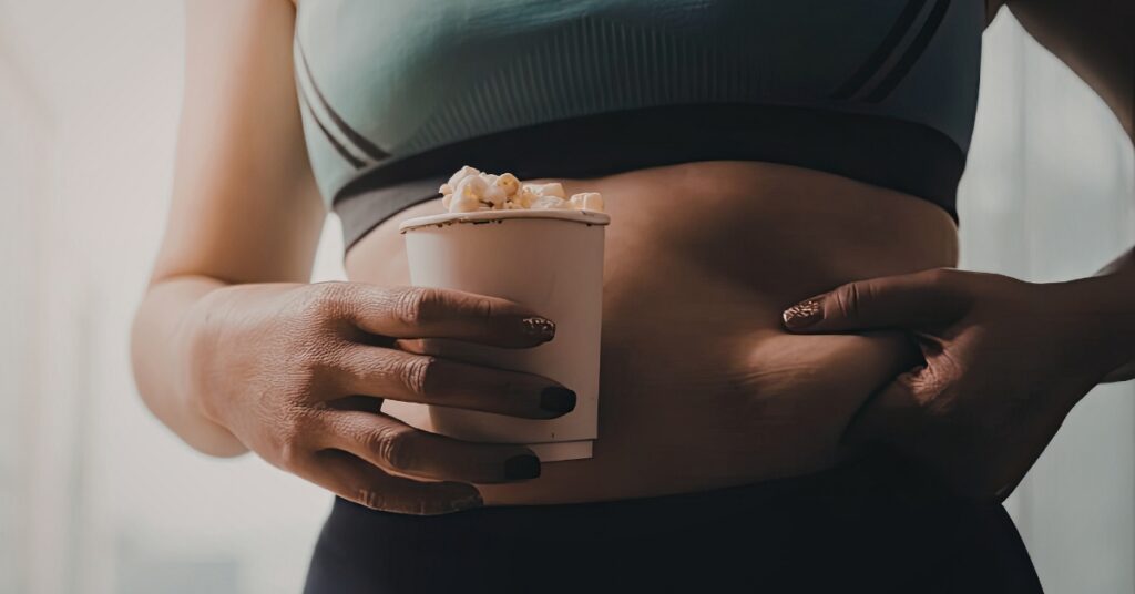 Woman experiencing abdominal discomfort and bloating during perimenopause