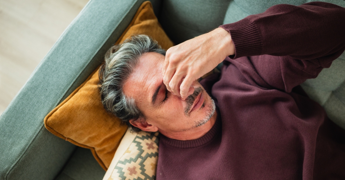 Tired man experiencing fatigue despite getting enough sleep