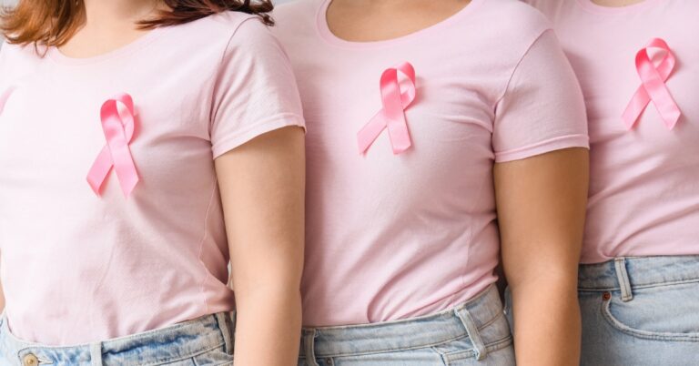 Women wearing pink with a breast cancer awareness ribbon
