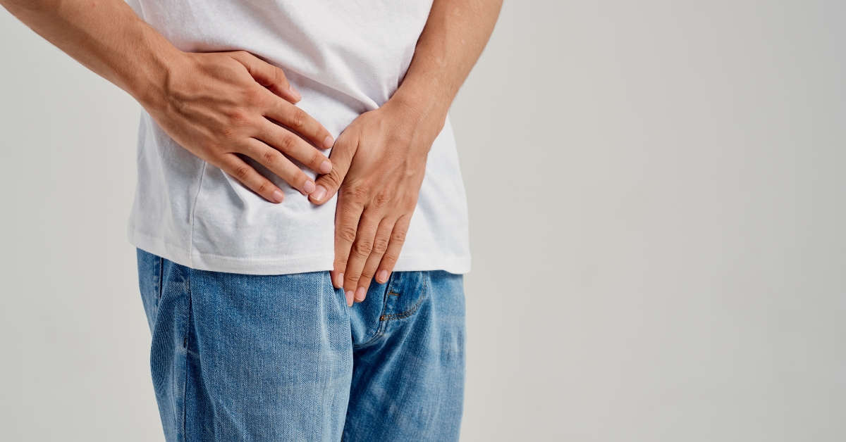 Man covering his groin area, representing erectile dysfunction and men's sexual health concerns