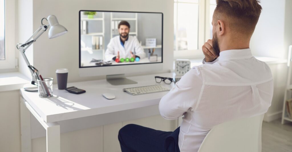 Man speaking with a doctor during an online consultation